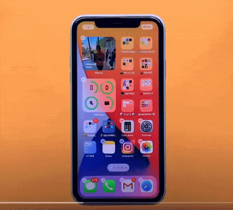 person showcasing iOS 14 features on iphone