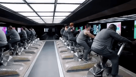 people exercising in front of tv screens